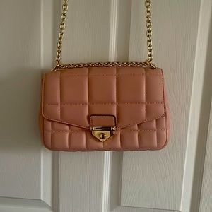 The bag is a Michael Kors Collection bag has been used